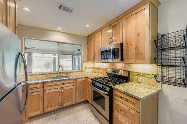 a kitchen with a stove a sink and a refrigerator