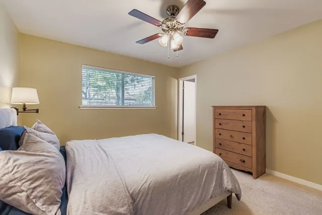 a bedroom with a bed a chandelier and a closet