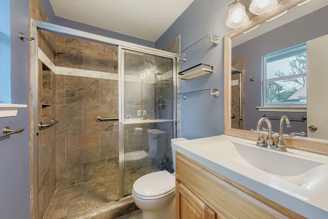 a bathroom with a sink toilet and shower
