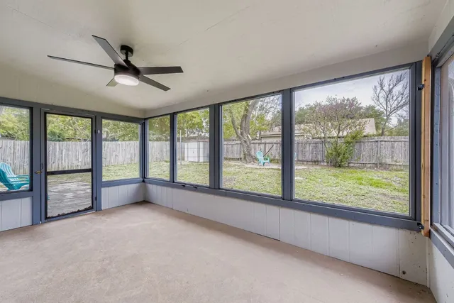 a view of an empty room with windows