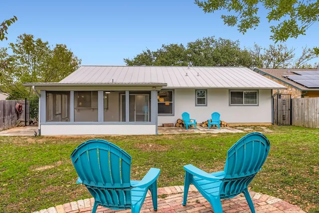 a view of a house with swimming pool and a yard