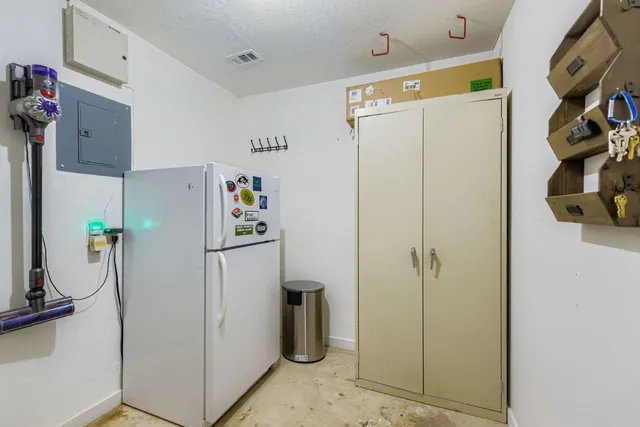 a white refrigerator freezer sitting inside of a kitchen