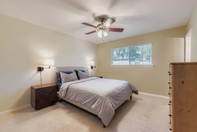 a bedroom with a bed and window