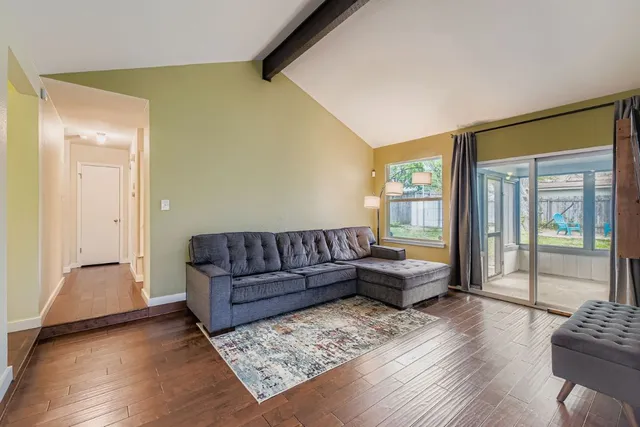 a living room with furniture and wooden floor