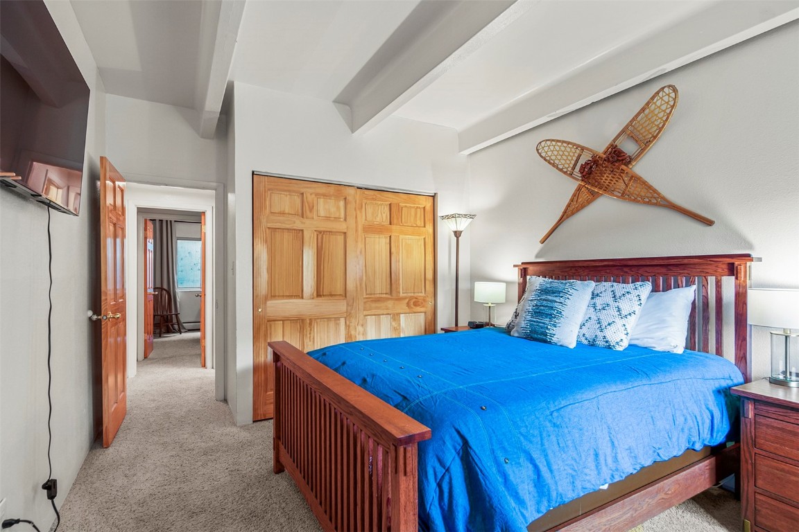 370 La Bonte Street, Unit F Dillon, CO 80435 - Photo 13 of 30 a bedroom with a bed and a dresser