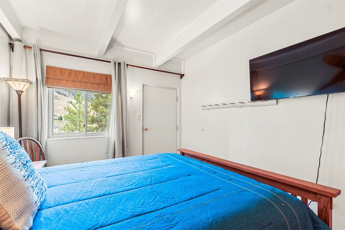 370 La Bonte Street, Unit F Dillon, CO 80435 - Photo 15 of 30 a bed sitting in a bedroom next to a window