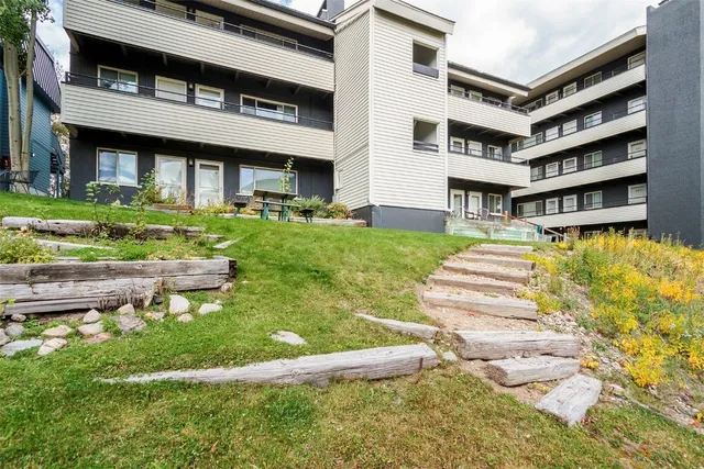 a front view of a house with a yard table and chairs