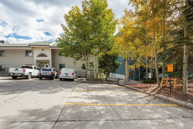 a couple of cars parked in front of a house