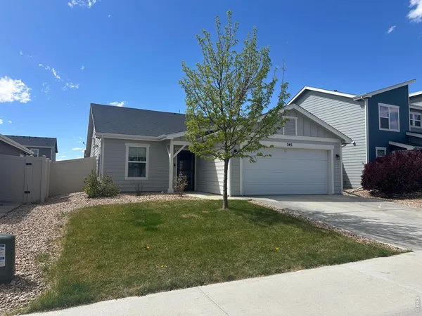 a house that has a tree in front of the house