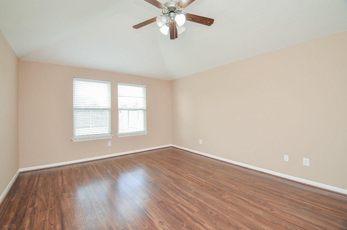 7134 Winston Ranch Parkway Richmond, TX 77406 - Photo 15 of 32 an empty room with wooden floor fan and windows
