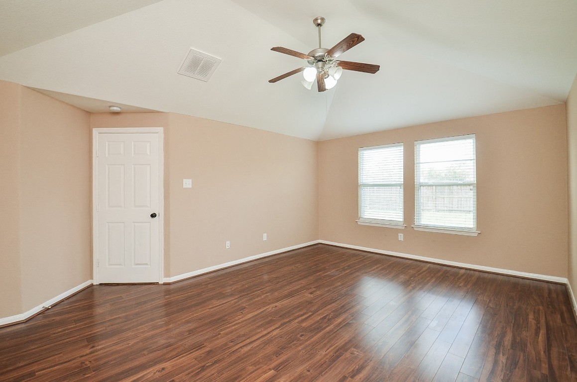 7134 Winston Ranch Parkway Richmond, TX 77406 - Photo 16 of 32 a view of an empty room with wooden floor and a window
