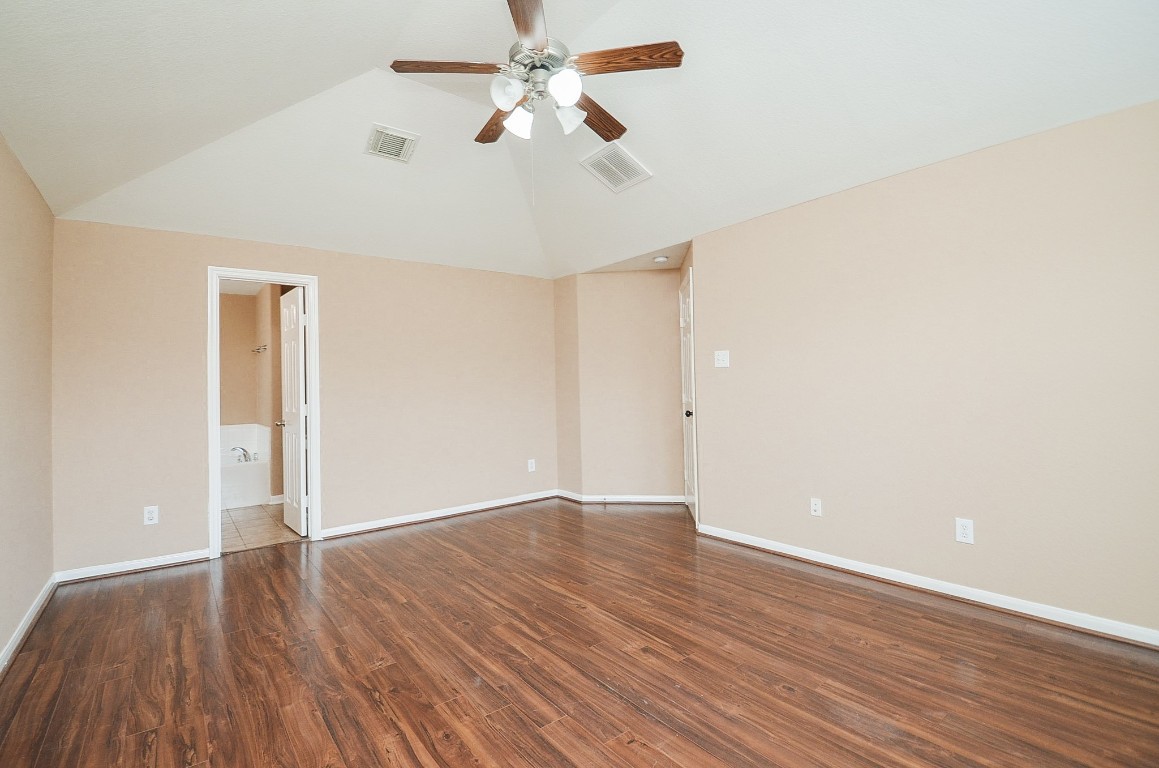 7134 Winston Ranch Parkway Richmond, TX 77406 - Photo 17 of 32 an empty room with wooden floor fan and windows