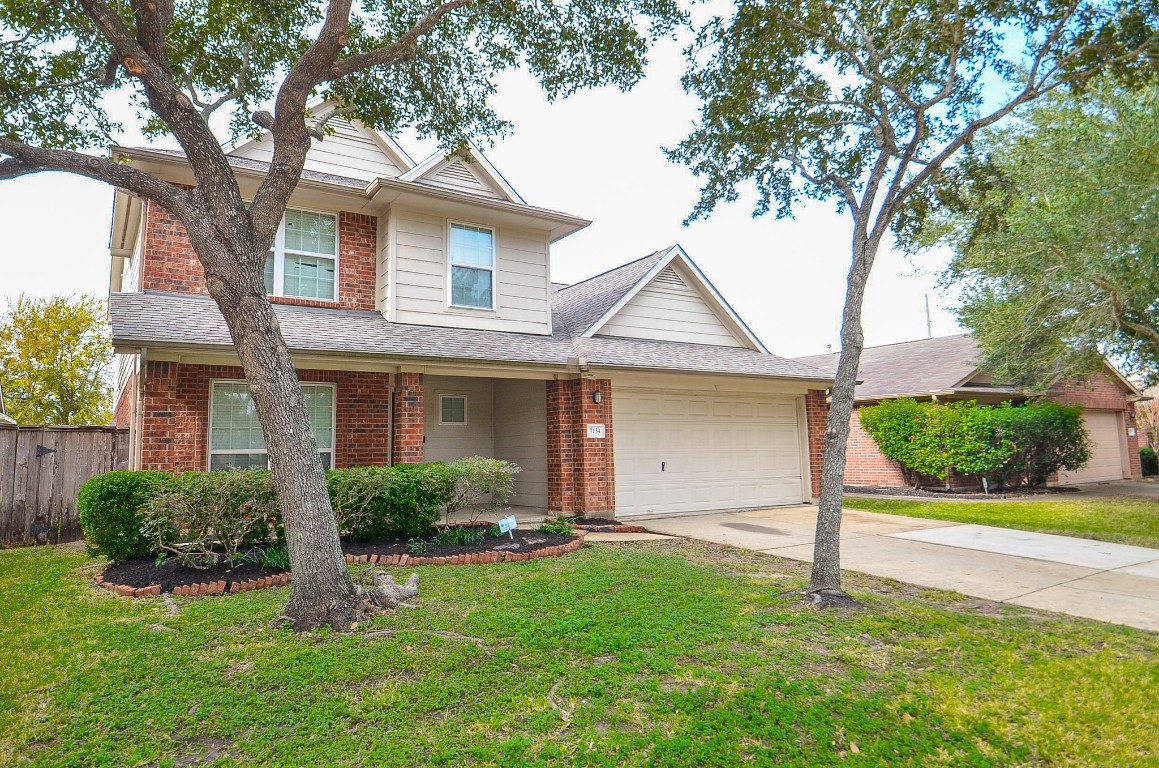 7134 Winston Ranch Parkway Richmond, TX 77406 - Photo 2 of 32 a front view of a house with a yard and garage