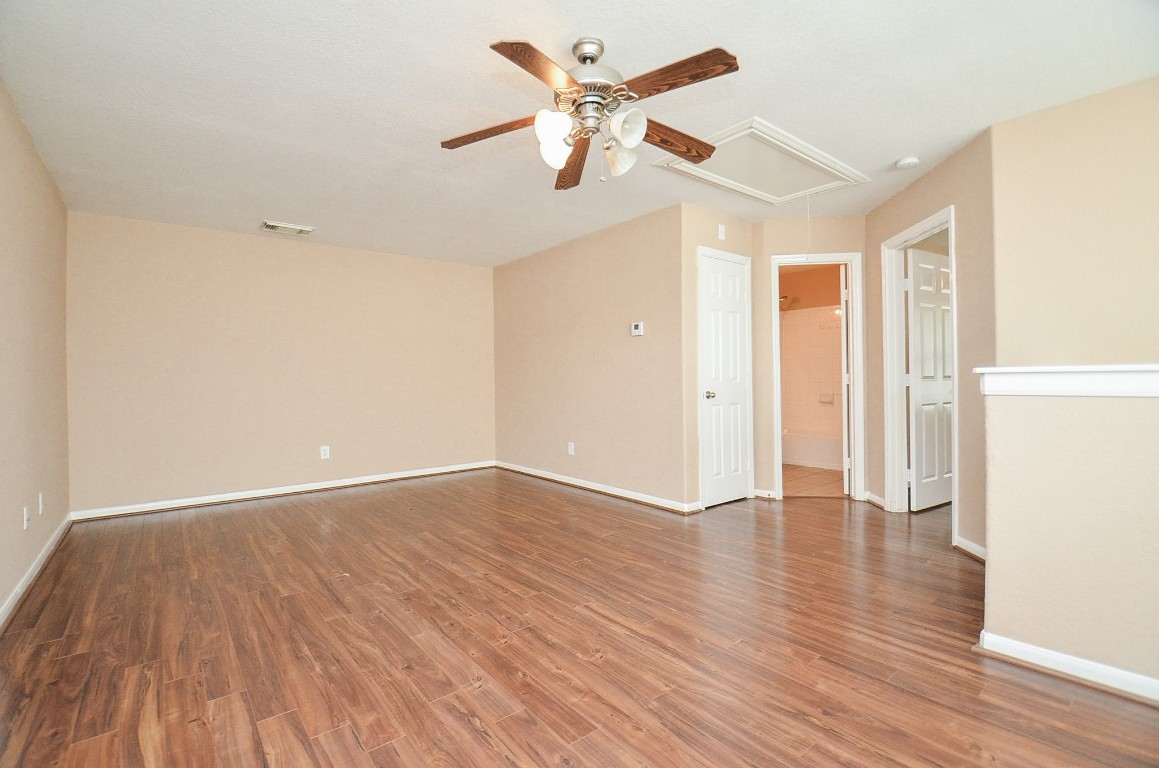 7134 Winston Ranch Parkway Richmond, TX 77406 - Photo 23 of 32 wooden floor in an empty room with a window