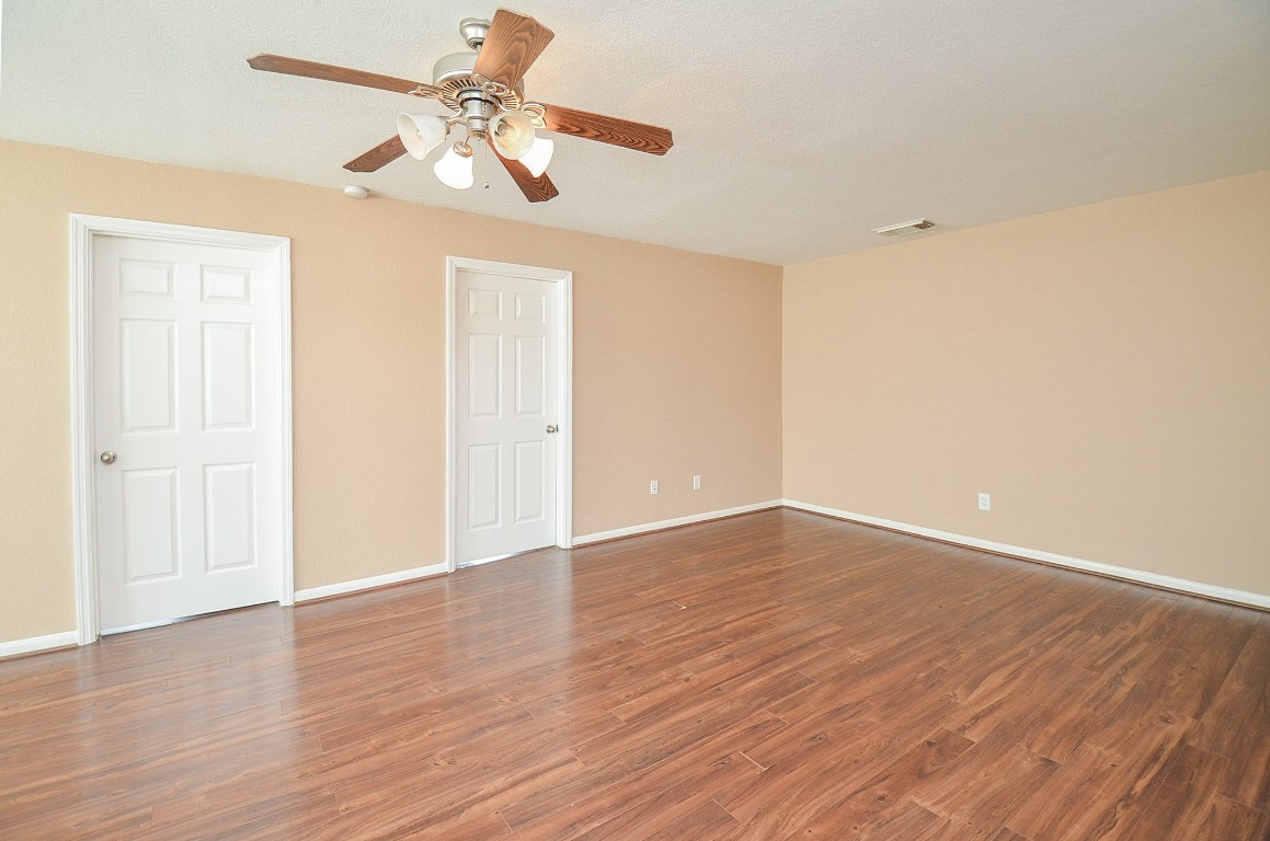 7134 Winston Ranch Parkway Richmond, TX 77406 - Photo 24 of 32 a view of an empty room with wooden floor