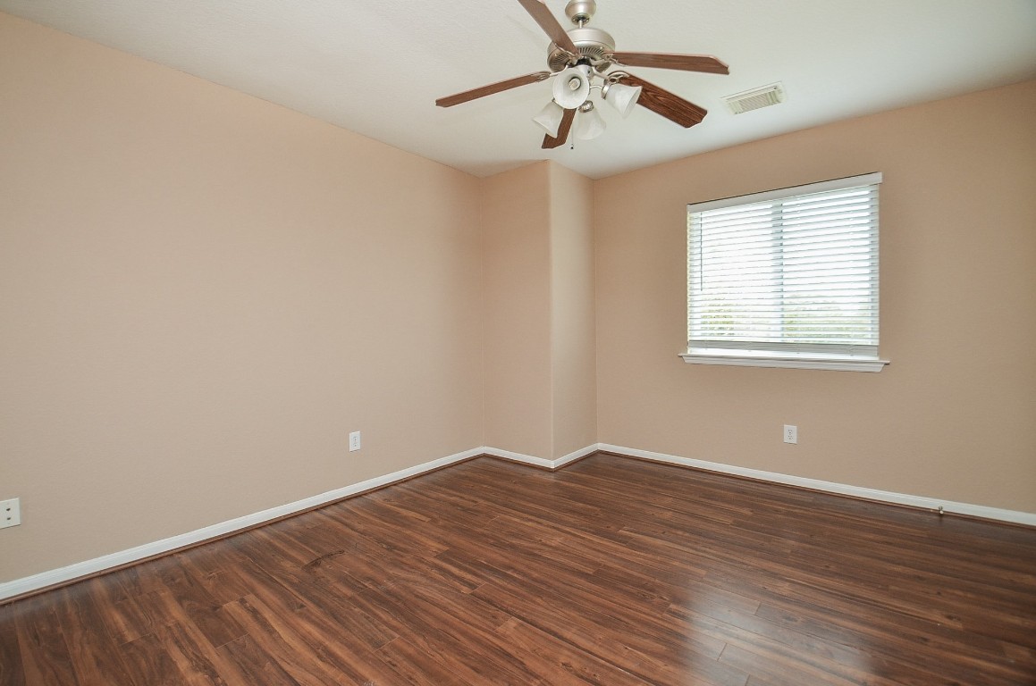 7134 Winston Ranch Parkway Richmond, TX 77406 - Photo 25 of 32 a view of an empty room with wooden floor and a window