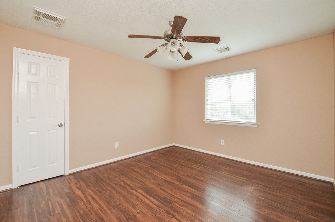 7134 Winston Ranch Parkway Richmond, TX 77406 - Photo 26 of 32 wooden floor in an empty room with a window