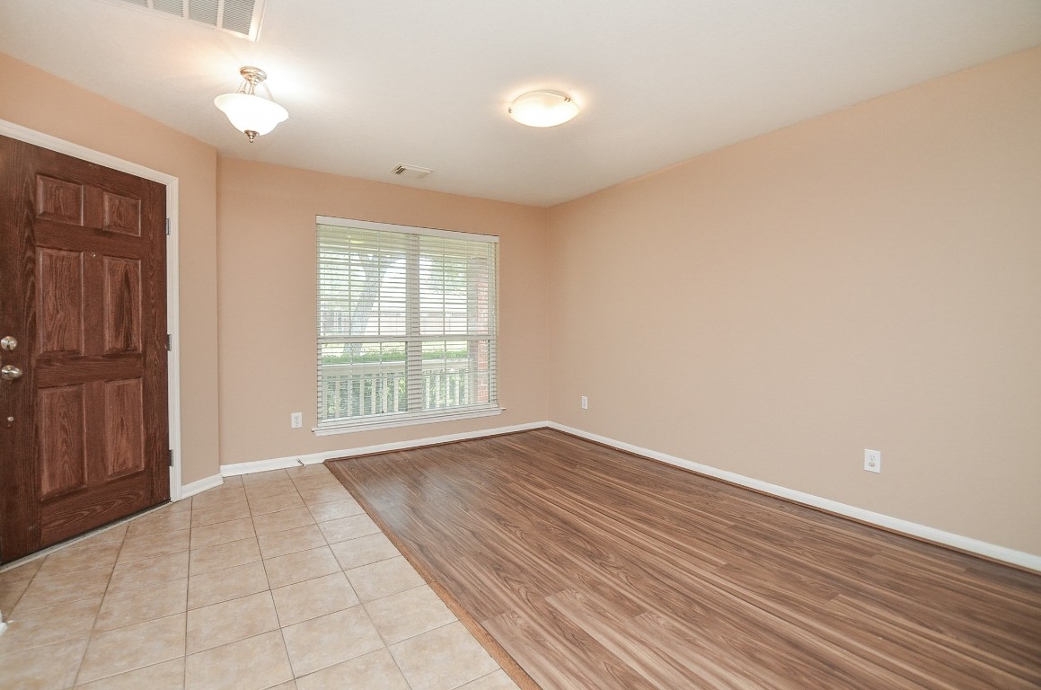 7134 Winston Ranch Parkway Richmond, TX 77406 - Photo 6 of 32 a view of an empty room with glass door and a window