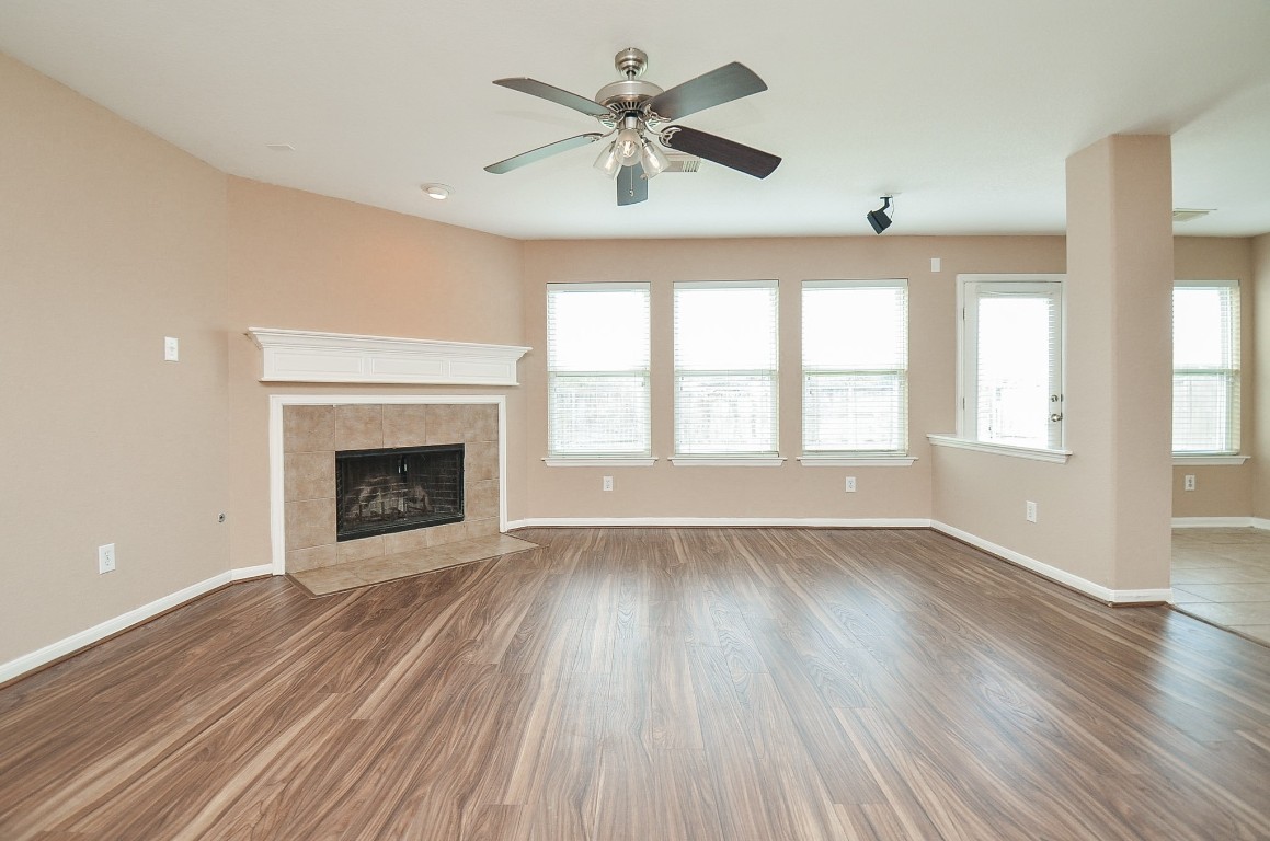 7134 Winston Ranch Parkway Richmond, TX 77406 - Photo 9 of 32 an empty room with chandelier fan and windows