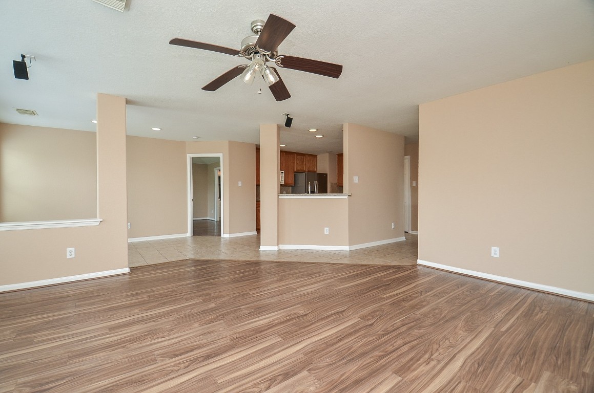 7134 Winston Ranch Parkway Richmond, TX 77406 - Photo 32 of 32 wooden floor in an empty room with a window