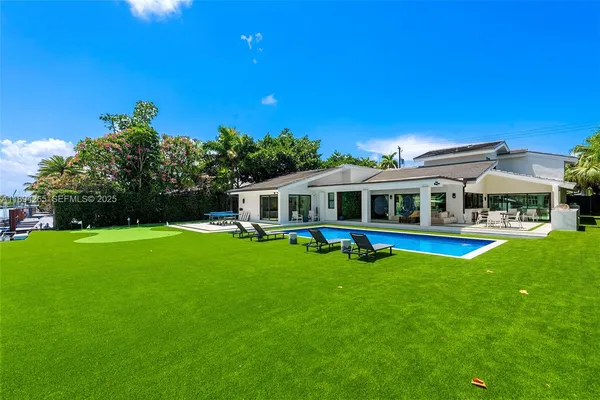 a view of swimming pool and chairs in patio