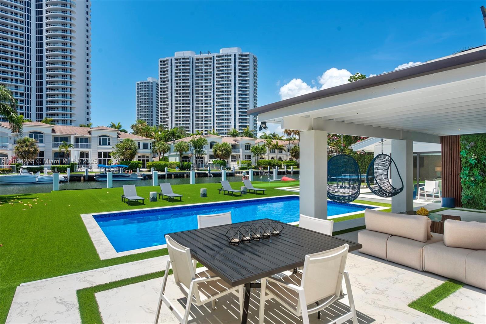 207 Holiday Drive Hallandale Beach, FL 33009 - Photo 15 of 50 a view of an chairs and table in a patio