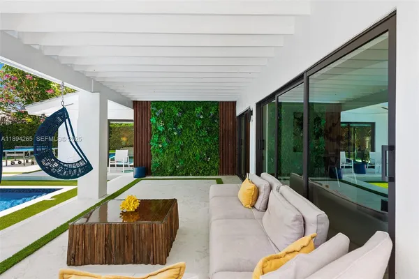 a living room with furniture and a potted plant