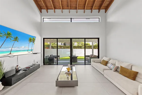 a living room with furniture and a floor to ceiling window