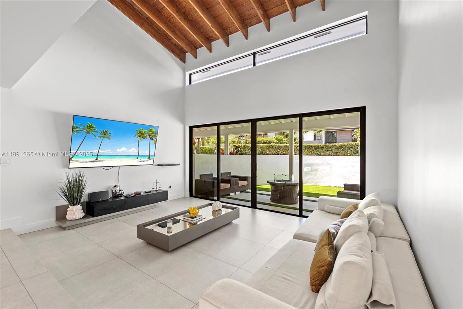 207 Holiday Drive Hallandale Beach, FL 33009 - Photo 26 of 50 a living room with furniture and a floor to ceiling window
