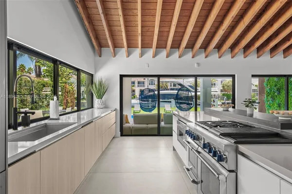 a large kitchen with a stove and cabinets