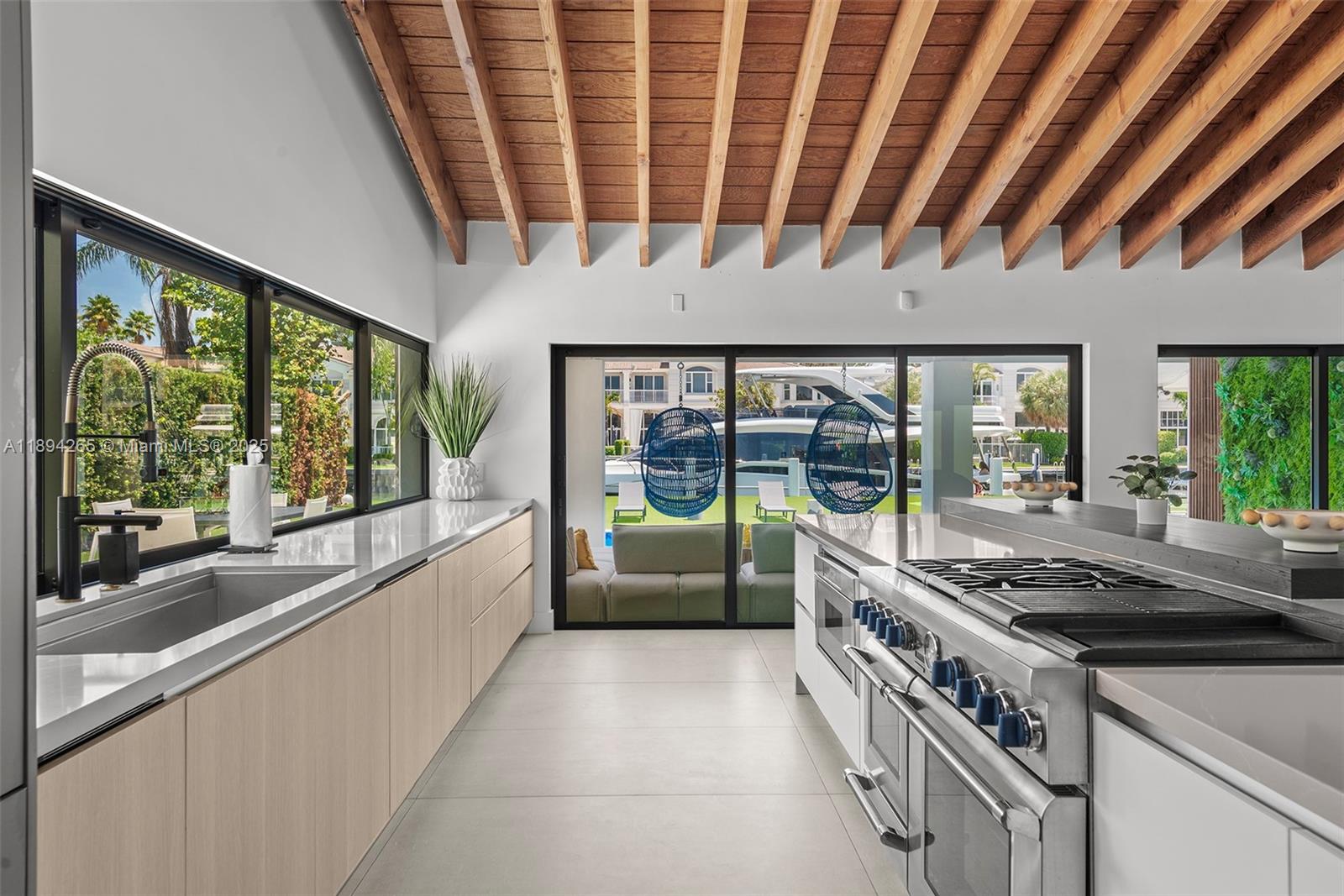 207 Holiday Drive Hallandale Beach, FL 33009 - Photo 28 of 50 a kitchen with stainless steel appliances granite countertop a sink and a counter space