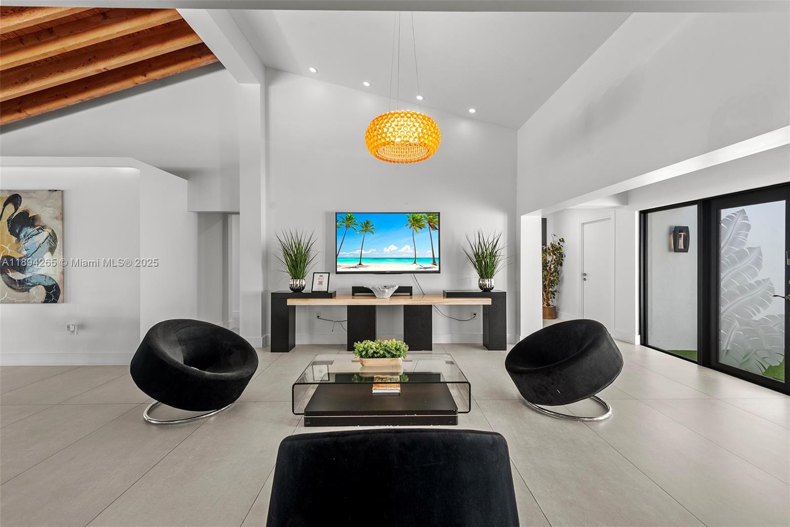 207 Holiday Drive Hallandale Beach, FL 33009 - Photo 30 of 50 a living room with a fireplace and a large mirror