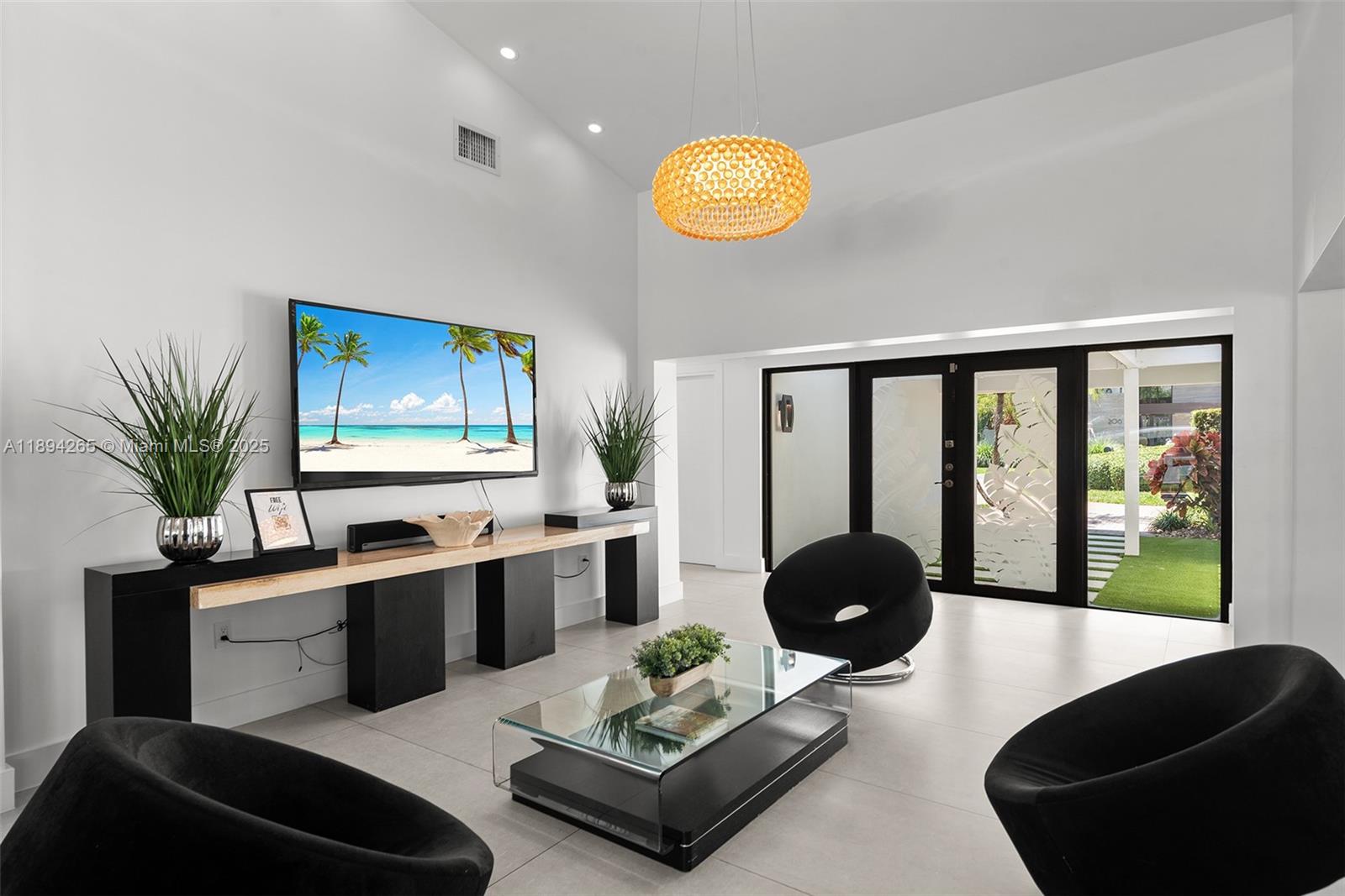 207 Holiday Drive Hallandale Beach, FL 33009 - Photo 32 of 50 a living room with furniture potted plant and a large window