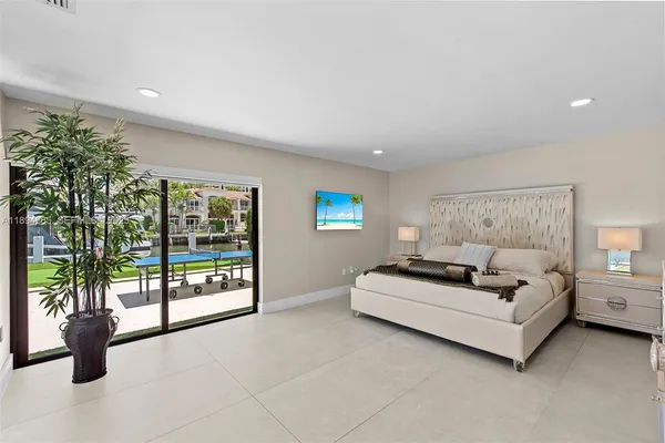 a bedroom with furniture and a large window