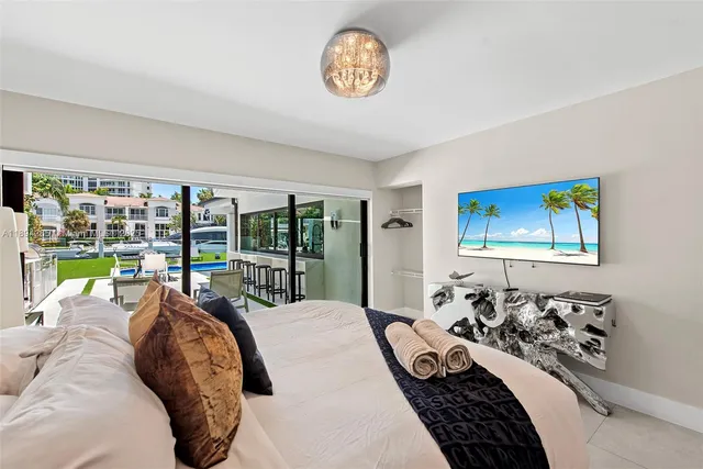 a bedroom with furniture and a large window