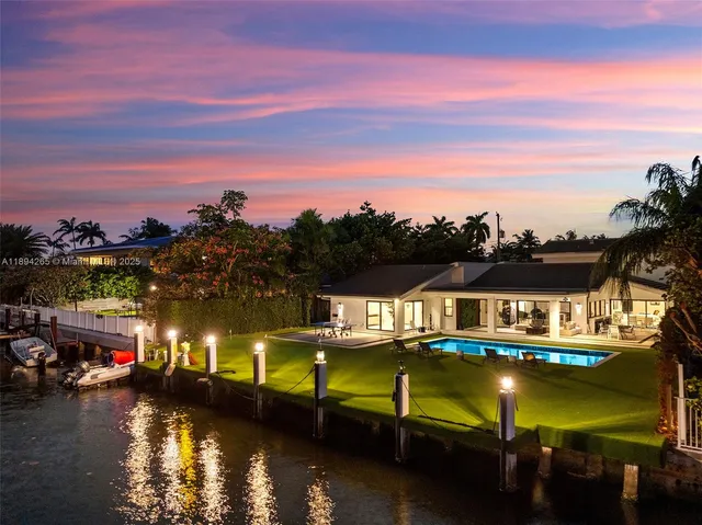 a front view of house with swimming pool yard and outdoor seating