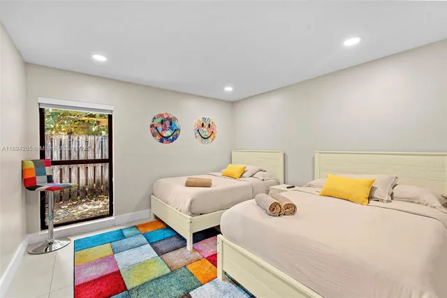 a bedroom with a large bed and a potted plant