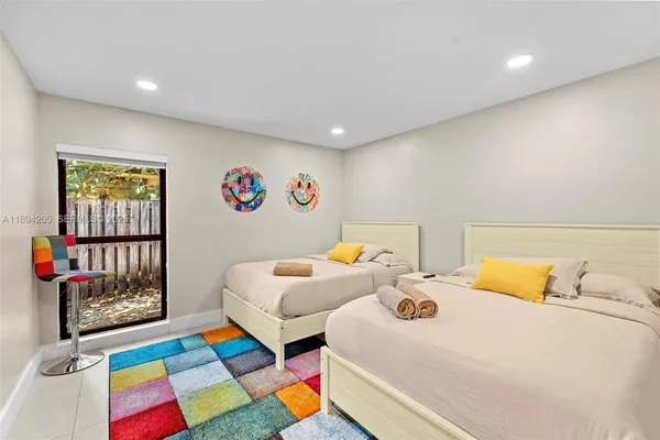 a bedroom with a large bed and a potted plant
