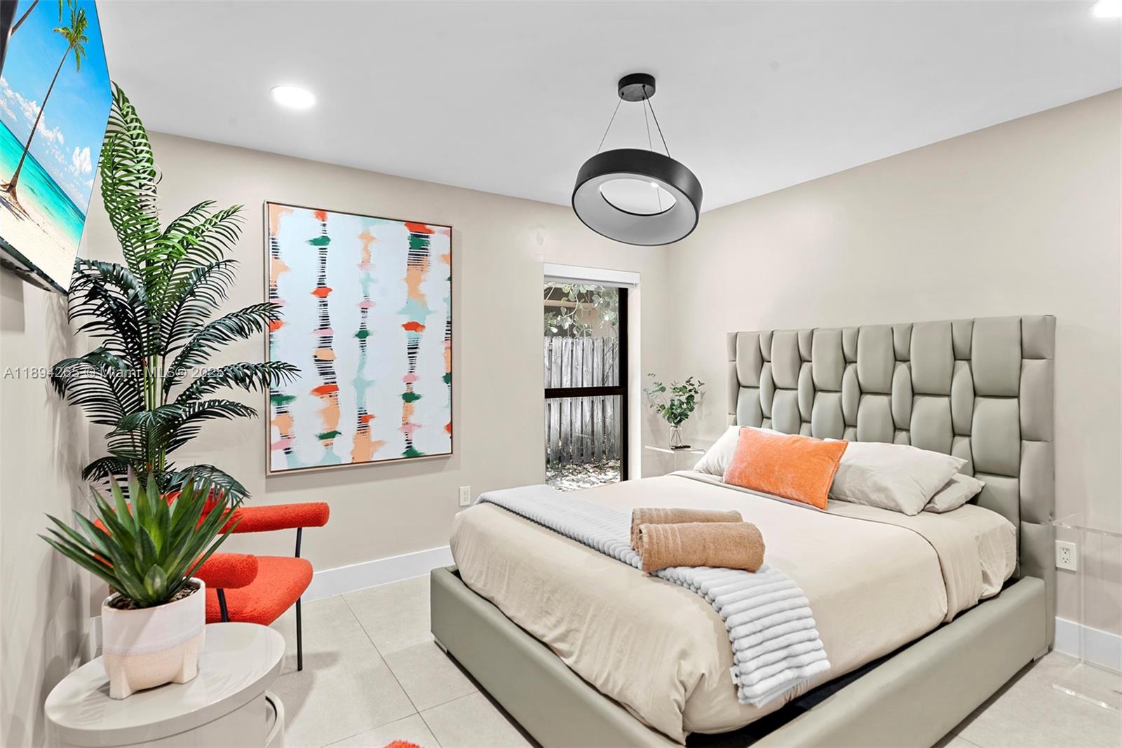 207 Holiday Drive Hallandale Beach, FL 33009 - Photo 43 of 50 a bedroom with a large bed and a potted plant