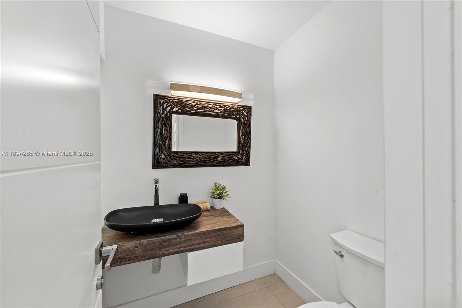 207 Holiday Drive Hallandale Beach, FL 33009 - Photo 46 of 50 a bathroom with a sink and a mirror