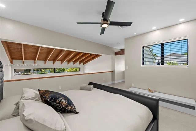 a living room with a couch and a floor to ceiling window