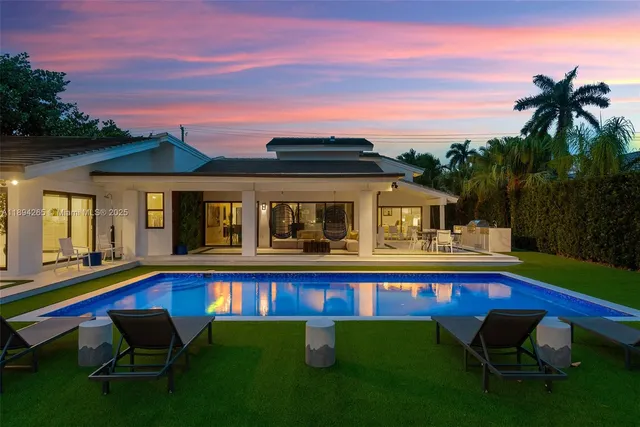 a aerial view of a house with swimming pool and yard