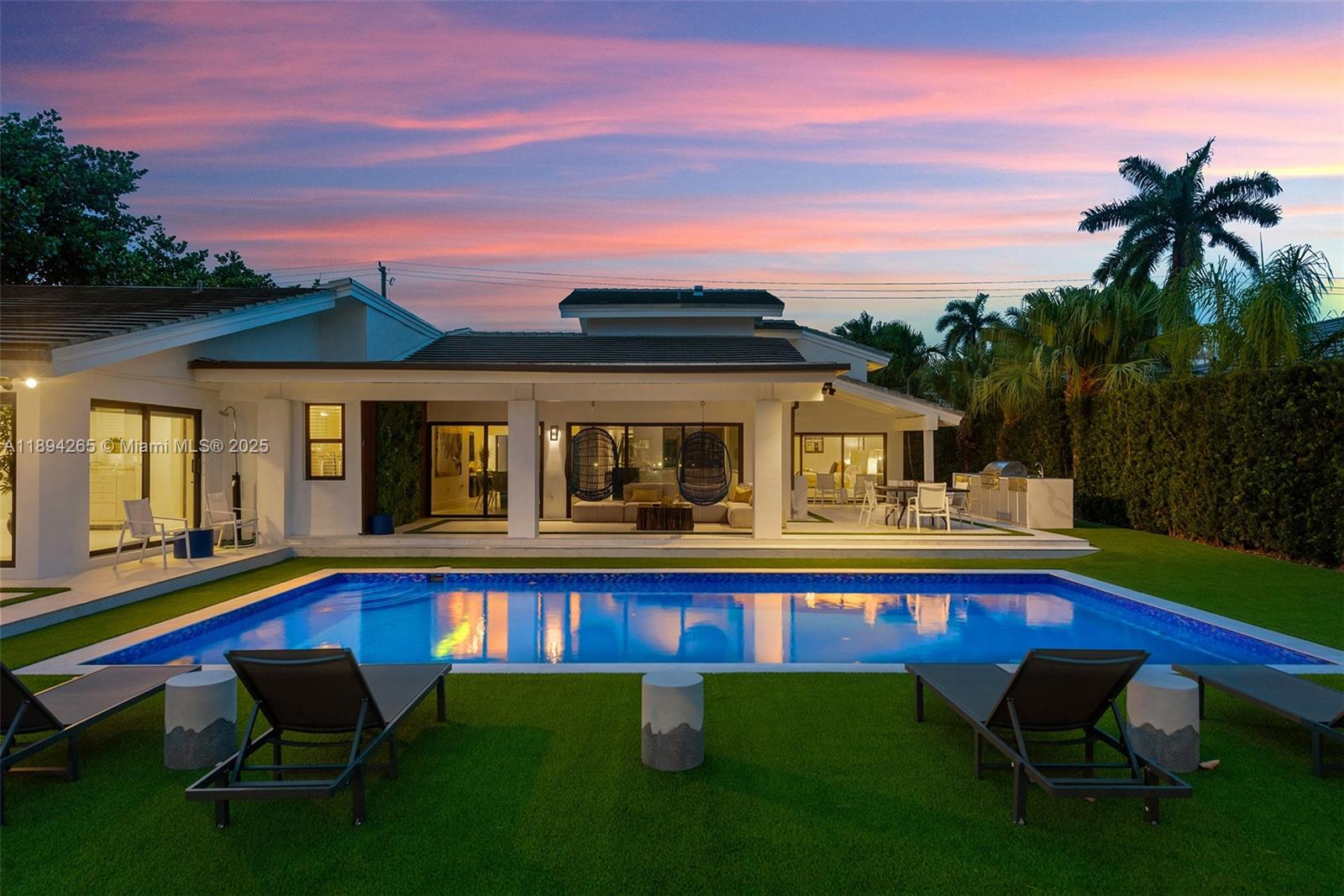 207 Holiday Drive Hallandale Beach, FL 33009 - Photo 5 of 50 a front view of house with swimming pool yard and outdoor seating