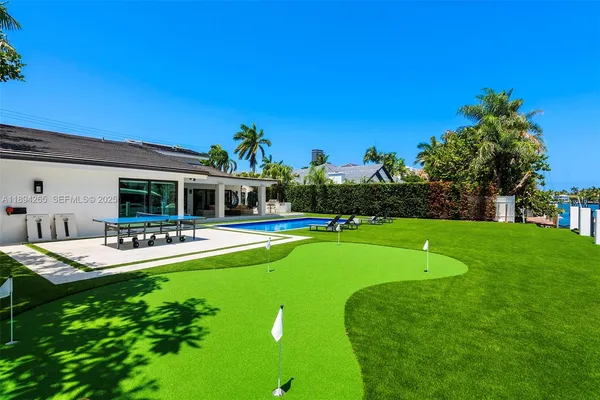 a view of a house with swimming pool and sitting area