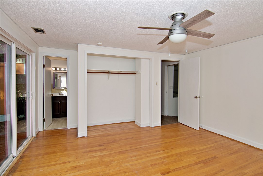 102 Broad Street Clemson, SC 29631 - Photo 18 of 40 A well-lit bedroom features hardwood flooring and a functional ceiling fan.