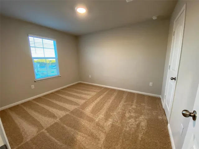 a view of an empty room with a bathroom