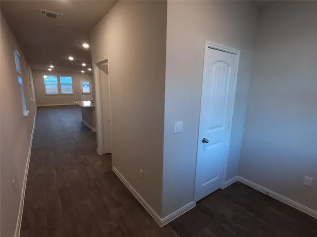 a view of hallway with wooden floor