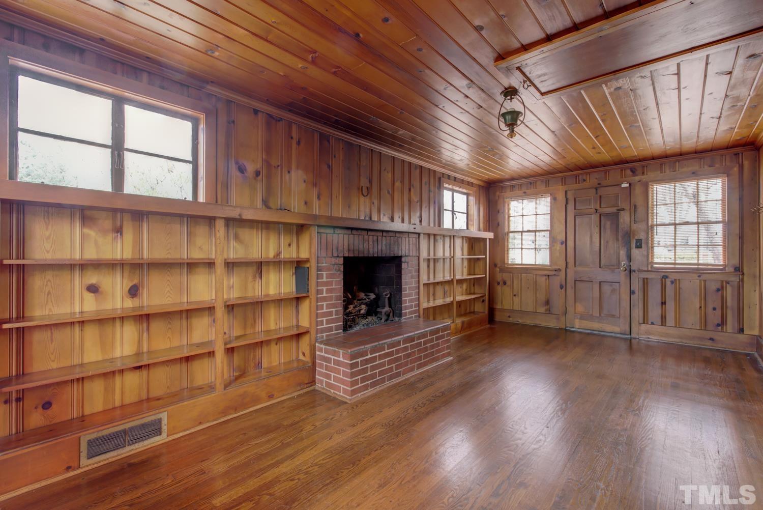 2601 London Drive Raleigh, NC 27608 - Photo 14 of 30 a view of empty room with wooden floor and fireplace