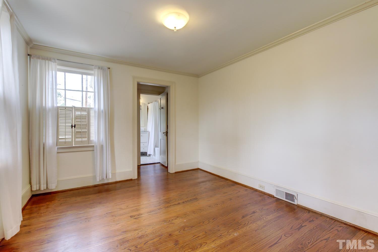 2601 London Drive Raleigh, NC 27608 - Photo 16 of 30 an empty room with wooden floor and windows
