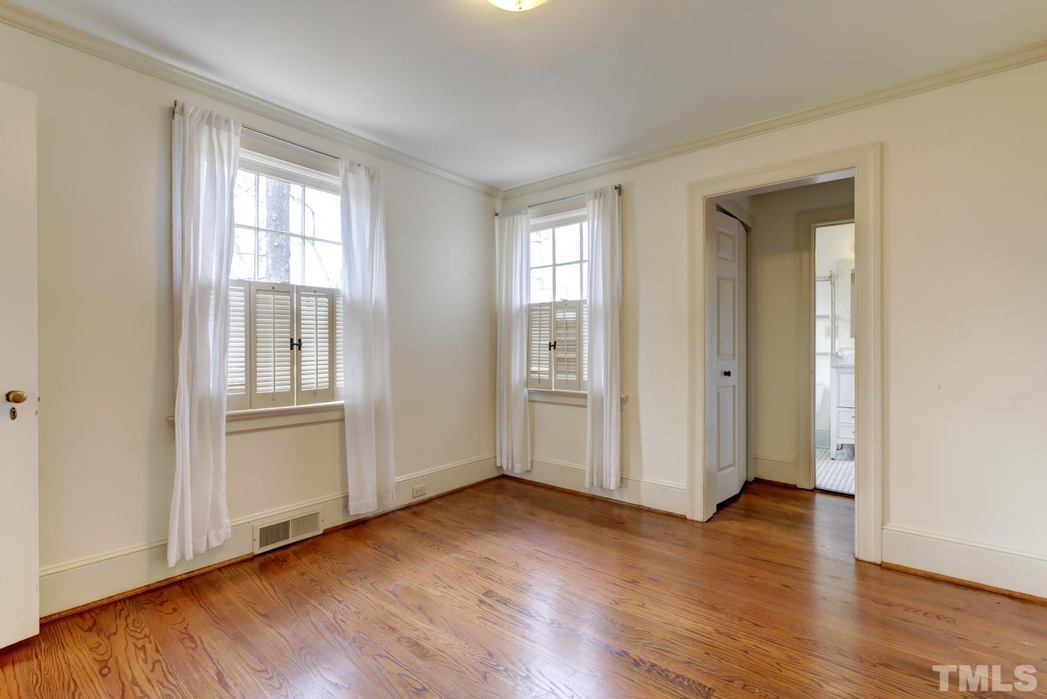 2601 London Drive Raleigh, NC 27608 - Photo 17 of 30 an empty room with wooden floor and windows